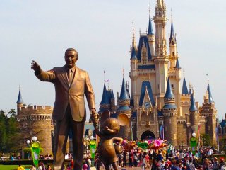 Walt Disney with his partner Mickey Mouse and the Cinderella Castle in the background