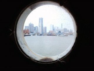 Nearby Minato Mirai 21 seen through one of the ship&#39;s portholes.&nbsp;