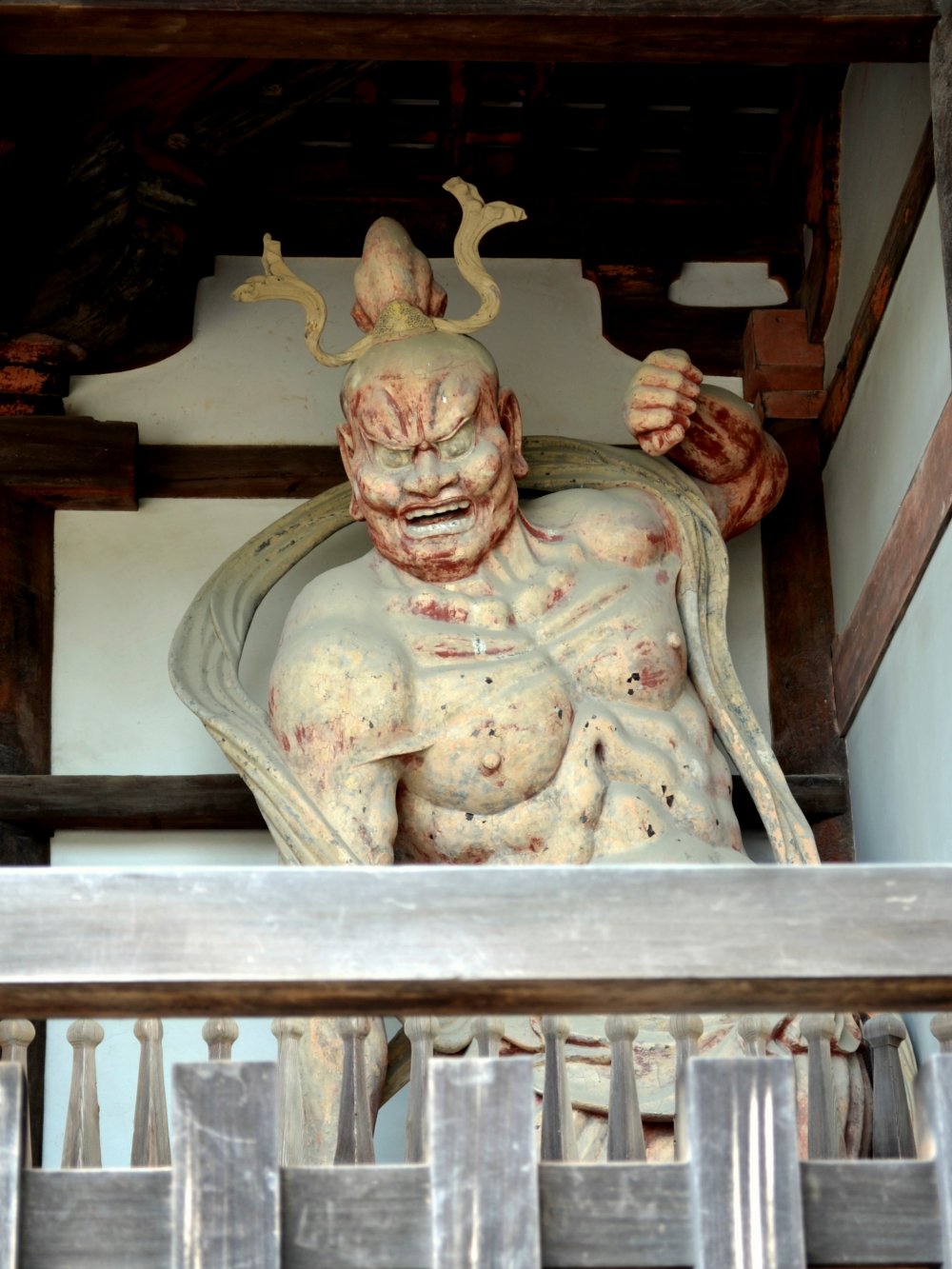 Statue of one of a pair of fierce guardian gods, keeping his mouth opening
