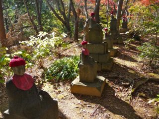 These little red capped statues run along the hiking path within and between the trees.  They impart a sense of watchfulness and protection