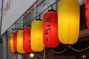 Distinctive red and yellow lanterns that welcome you to Kushikatsu Tanaka
