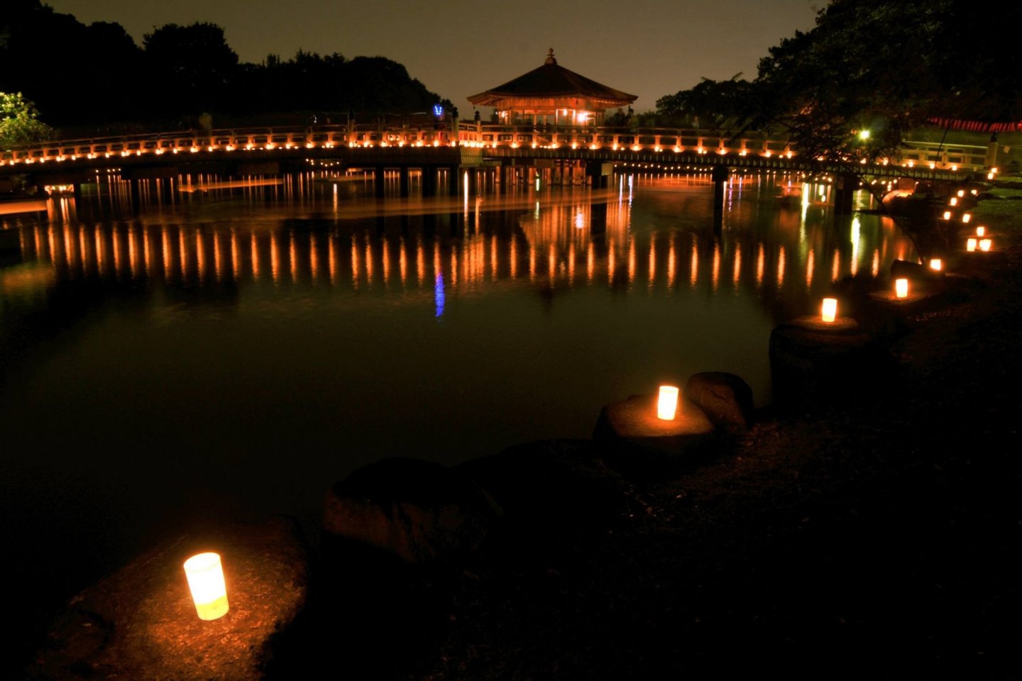 Lanterns from the Tokae and boats reflected in a pond in Nara Park