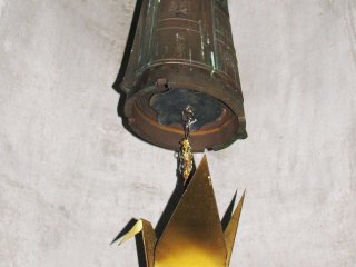 A bell inside the memorial with a crane