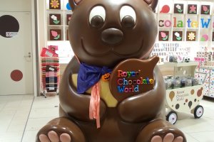 Big cute brown bear welcoming visitors