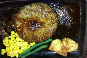 Seasoned hamburger plate with savory sauce and vegetables