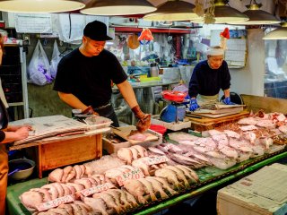 Vendors carefully prepare the fresh seafood for the mostly local customers