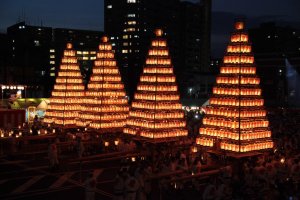 Towers of lanterns are carried during the Tobata Gion Festival