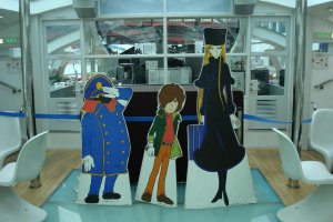 Cutouts of Matsumoto&#39;s Galaxy Express 999 characters aboard Himiko.