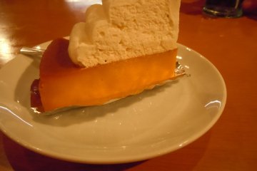 <p>My husband&#39;s dessert: rich, sweet, Japanese version of pumpkin pie topped with cream (250 yen). I think I might opt for that next time. I ordered cheesecake (270 yen) which was good, but needed fruit or some other flavor besides sugar. What a great big dose of sugar! We refreshed after dessert with a glass of water</p>