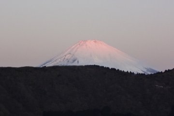 The top of snow-covered Mt. Fuji can be seen from the hotel entrance on sunny mornings.
