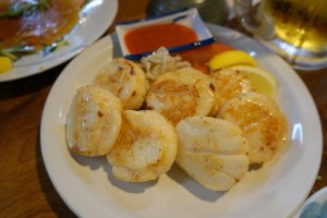 Fresh scallops or &quot;hotate&quot; from the Hokkaido area of Japan. Simply prepared and delicious - or as they say in Japan &quot;oishii.&quot; The scallops and other seafood served here are not farmed raised, Andy will tell you. Andy has 20 plus years navigating Tsukiji fish market and knows his fish!