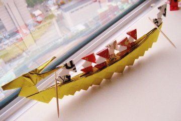 Origami dragon boat complete with tiny passengers