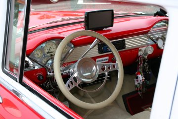 <p>The immaculate interior of a 1956 Chevy Bel Air with a touch of modern convenience</p>