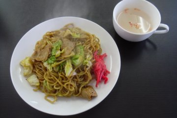 <p>Steaming hot yakisoba, prepared before your eyes. All orders come with soup, a clear broth that in this case had tiny shrimps added to it.</p>