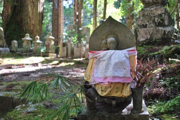 <p>Okunoin is Japan&#39;s largest cemetery, housing over 200,000 grave markers and memorials. &nbsp;A common sight along the walking trails are Jizo figures. &nbsp;Jizo is a protector of travelers and the weak, particularly children. &nbsp;Children who die before their parents are sent to &quot;limbo&quot;, and parents care for these Jizos to placate their children in the afterlife.</p>
