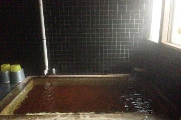 <p>A traditional wood ofuro or communal bath welcomes you at the Tazawako Youth Hostel</p>