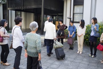 <p>The audience trying to catch time with the tsuzumi master, pictured in the middle, who played on the kotsuzumi (small drum) during the main noh performance</p>