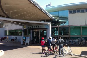 A family returns their rental bikes at Sunrise Itoyama
