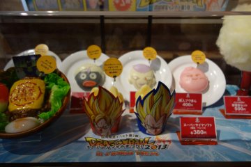 Window preview of Dragon Ball-themed food items inside J-WORLD Kitchen