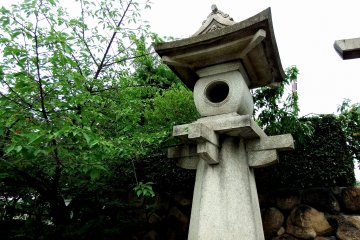 <p>Stone lantern standing at the entrance of Hōkoku Shrine</p>