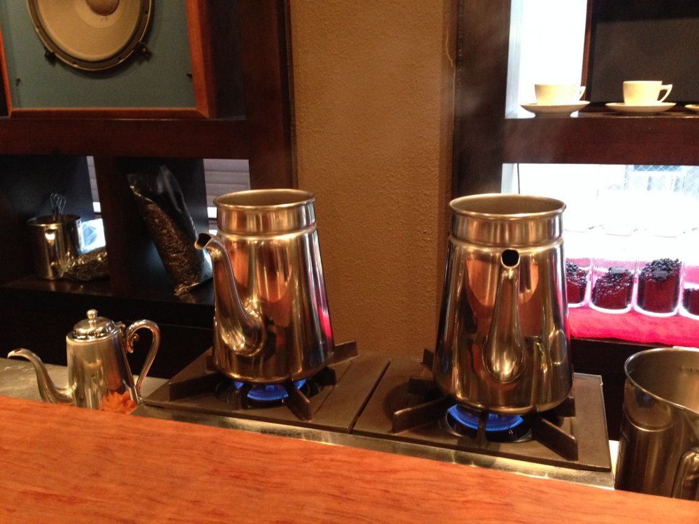 Coffee brewed in silver pots - maybe turkish style?