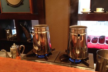 <p>Coffee brewed in silver pots - maybe turkish style?</p>