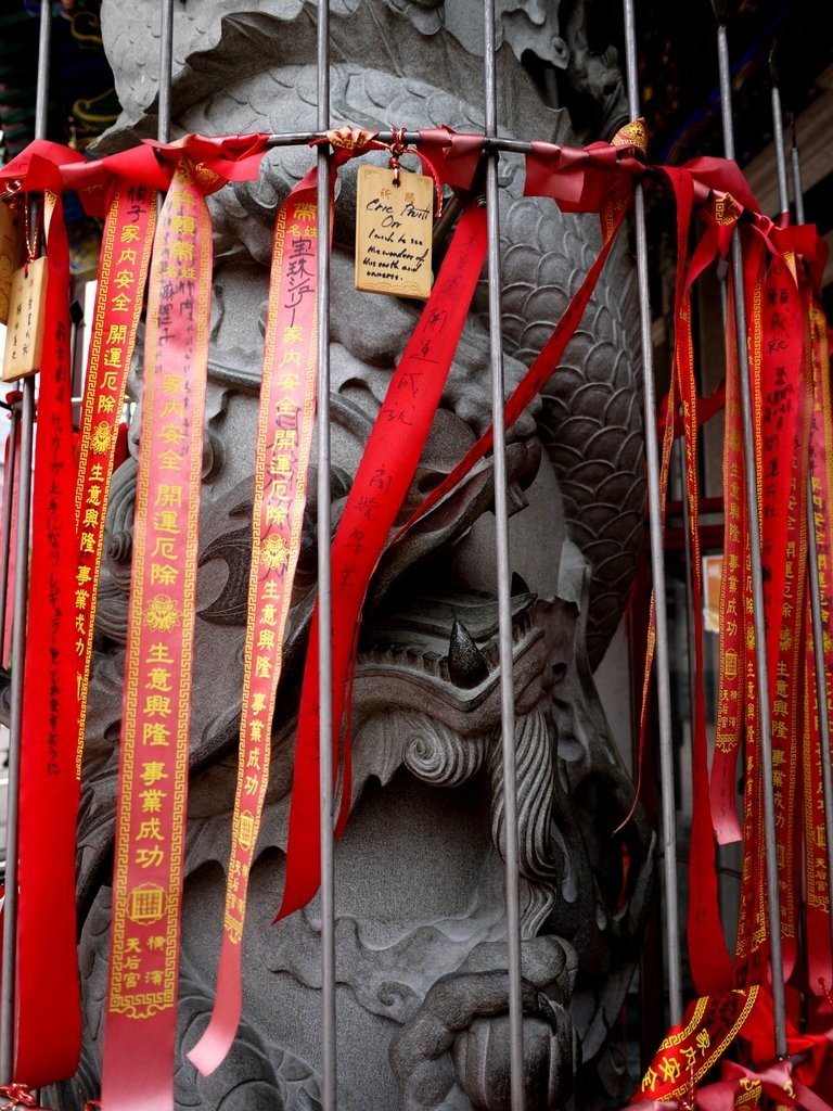 A dragon hides behind red ribbons