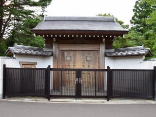 Another mausoleum of the Date clan and a wooden gate with the clan&#39;s crest
