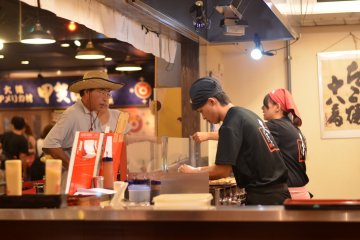 <p>Takoyaki masters painstakingly cooking the delicious Takoyaki.</p>