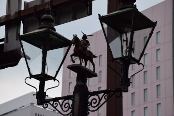 <p>Gas lamp decorated with miniature statue of Lord Date Masamune</p>
