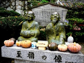 Monk statues with pumpkins