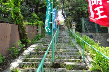 <p>another temple with a set of stone steep steps adorned with colorful flags that led up to a small quiet temple.</p>