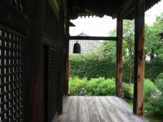 A bell hangs at the end of the verandah