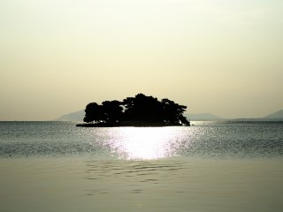 Le soleil se couche &agrave; l&#39;ouest mais il reste encore un peu de temps avant le coucher de soleil. L&#39;&icirc;le Yomegashima est alors sublim&eacute;e par une lueur argent&eacute;e
