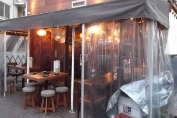 <p>There are a few outside tables on the corner</p>