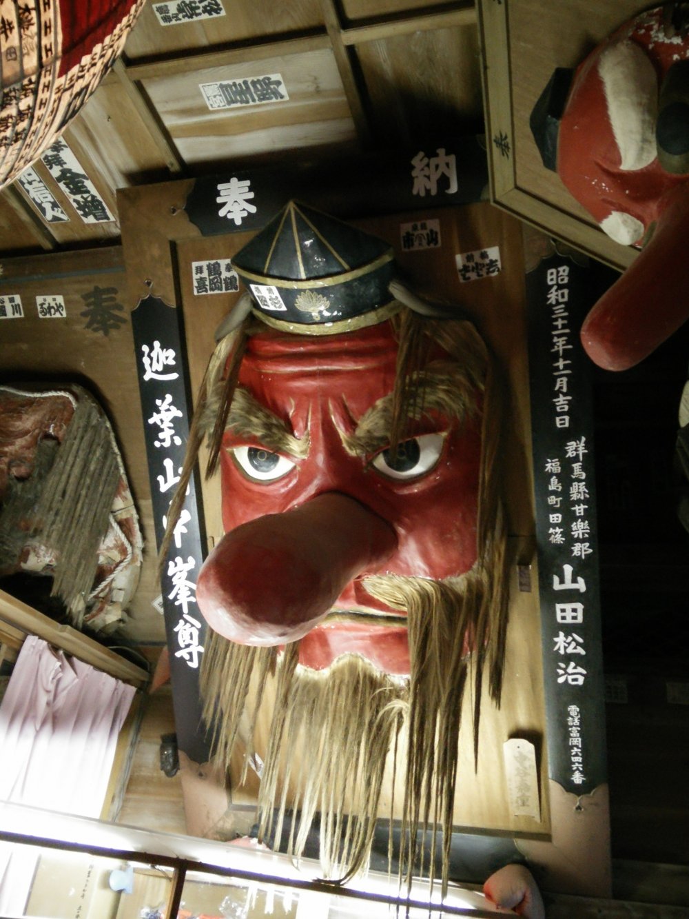 A bearded Tengu watches from up high