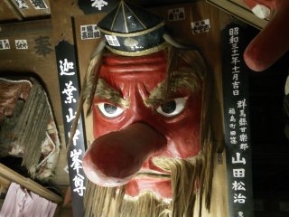 A bearded Tengu watches from up high