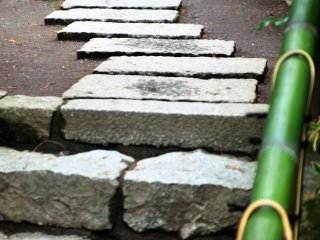 Paved stones at Nanzen-in and a green bamboo rail