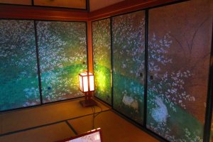 Brightly colored cherry blossoms decorate a wall-screen inside
