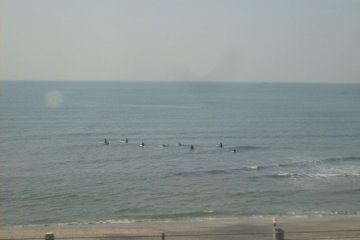 <p>Some surfers taking on the waves around Shichirigahama</p>