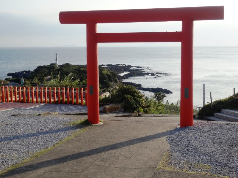 <p>A view of the lighthouse on Cape Nagasakibana through the torii gate of Ryugu Shrine</p>