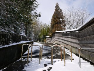 A trail into the hills begins at these steps near Rokusho Shrine