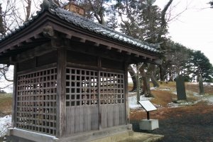 Inside this wooded structure lies one of the three oldest stone historical markers in Japan