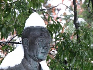 Close-up look at the snow-capped statue of the monk Taicho. Come rain or come snow, his face is always serene.