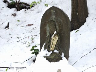 Small Kannon statue looking happy even though half-buried in snow!