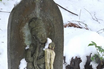 <p>Close-up look at the happy-faced Kannon statue</p>