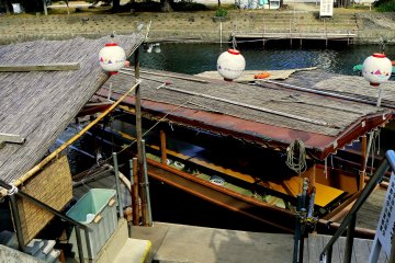 <p>A table with tatami mat seating runs the length of this tourist boat</p>