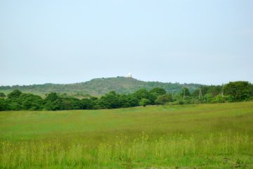 <p>Across the meadow, you can see the radar observatory of Mt. Monomi</p>