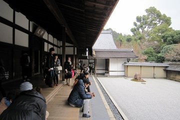 <p>Tourists relaxing in front of the rock garden</p>