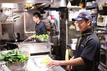 <p>Sakamoto-san and Wai-san busy in the kitchen</p>